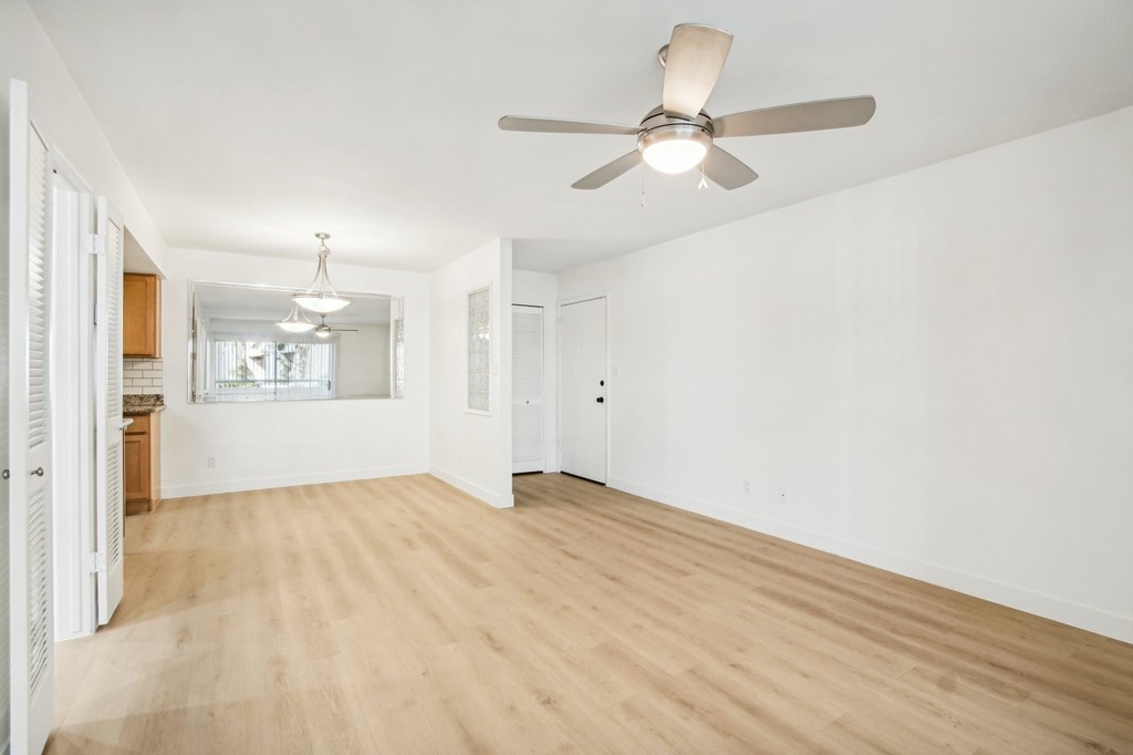 A room with a ceiling fan and wooden flooring. at The Viridian Apartments, Scottsdale 85250