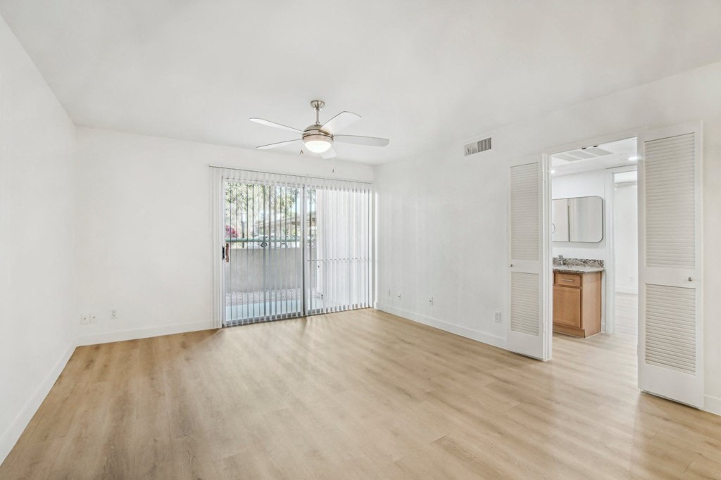 A room with a sliding glass door and a ceiling fan at The Viridian, Scottsdale, AZ