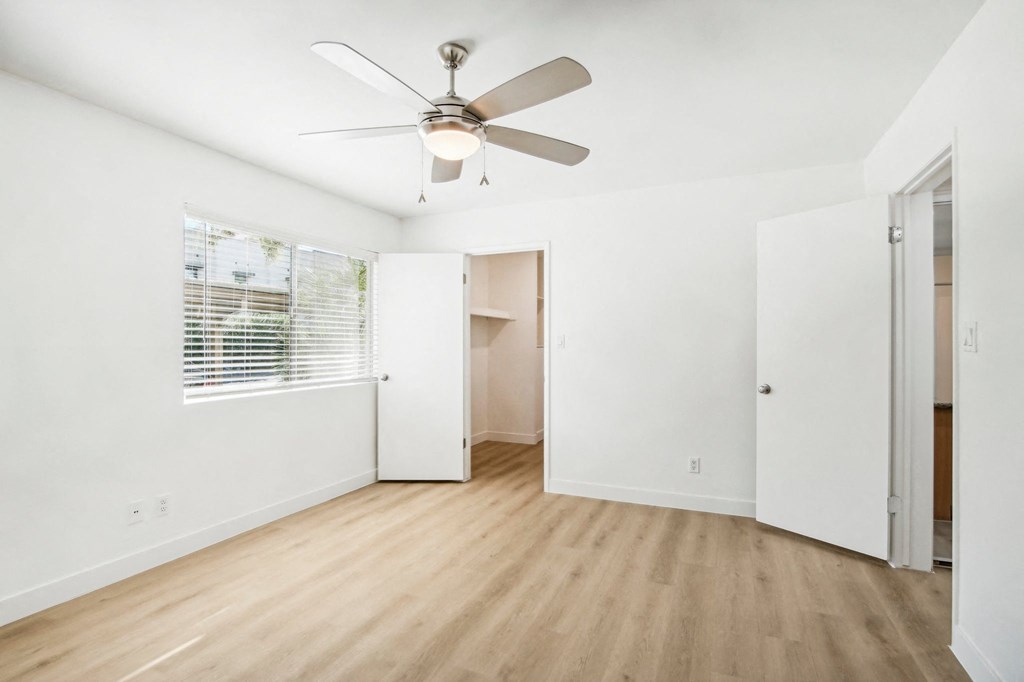 A room with a ceiling fan and a window with blinds at The Viridian, Scottsdale, AZ