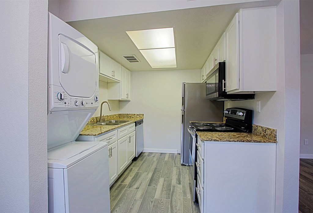 A kitchen with white appliances and cabinets at Aspire Mesa, Mesa.