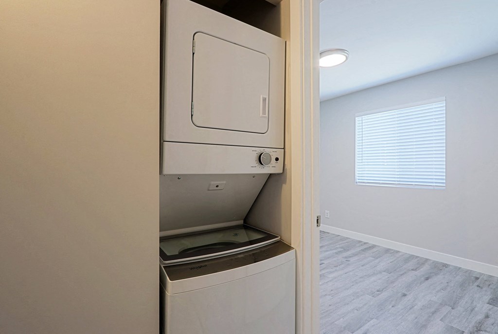 A white dishwasher is built into a kitchen wall.
