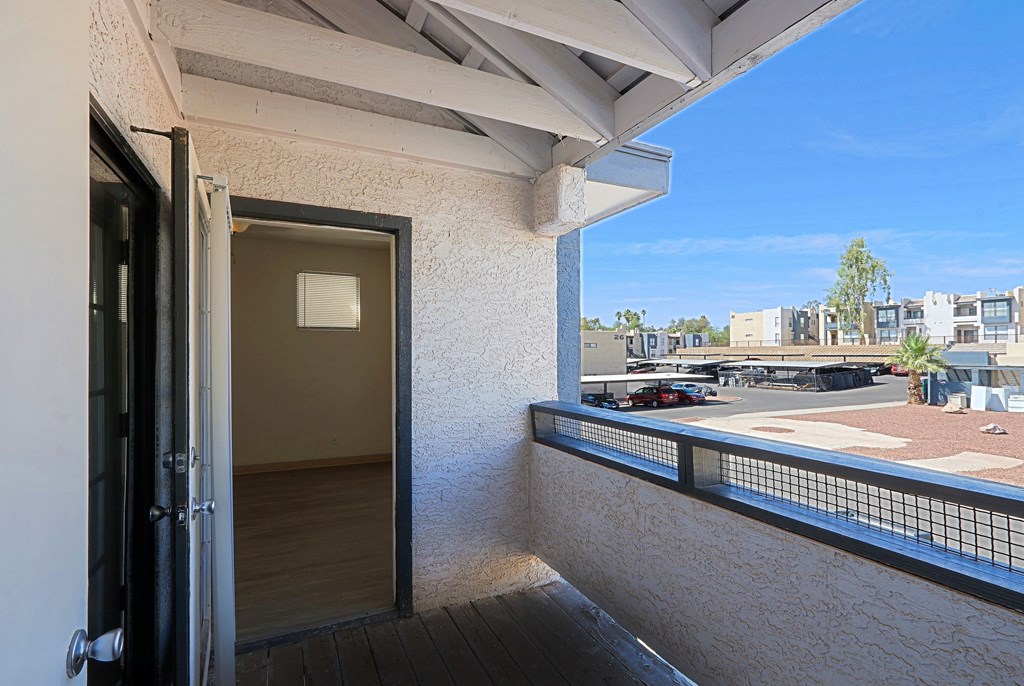 a balcony with a door and a view of the city
