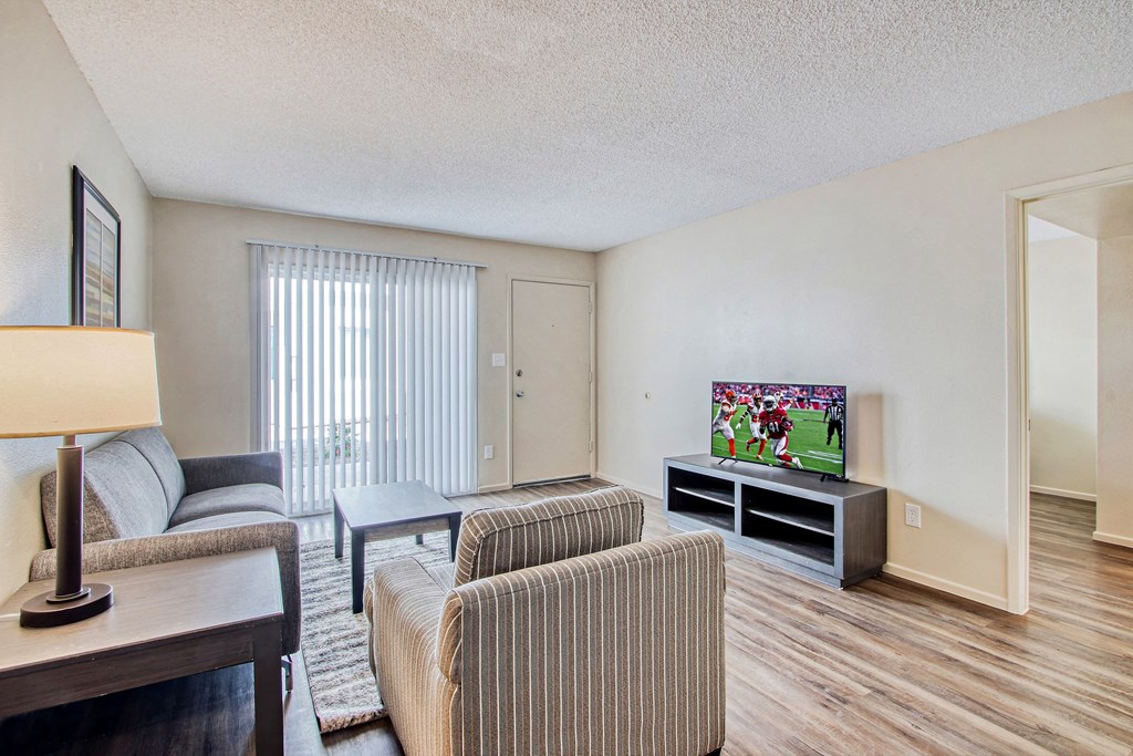 the living room of our apartments with a tv