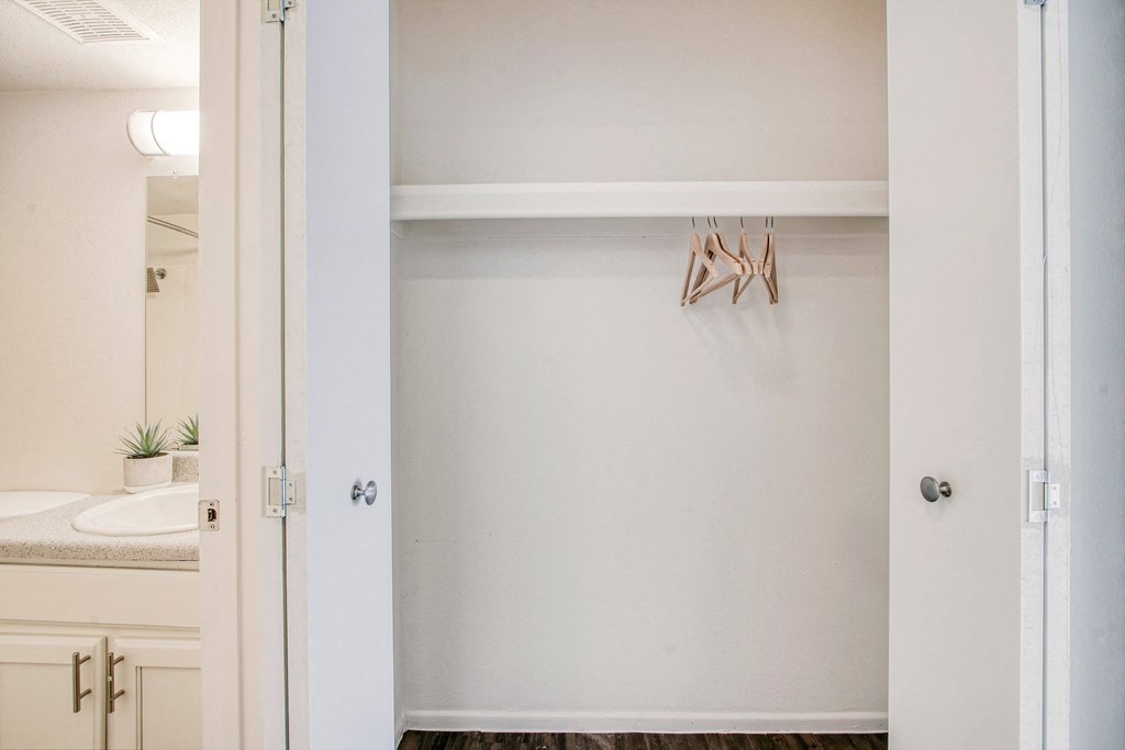 a bathroom with a sink and a mirror and an open door