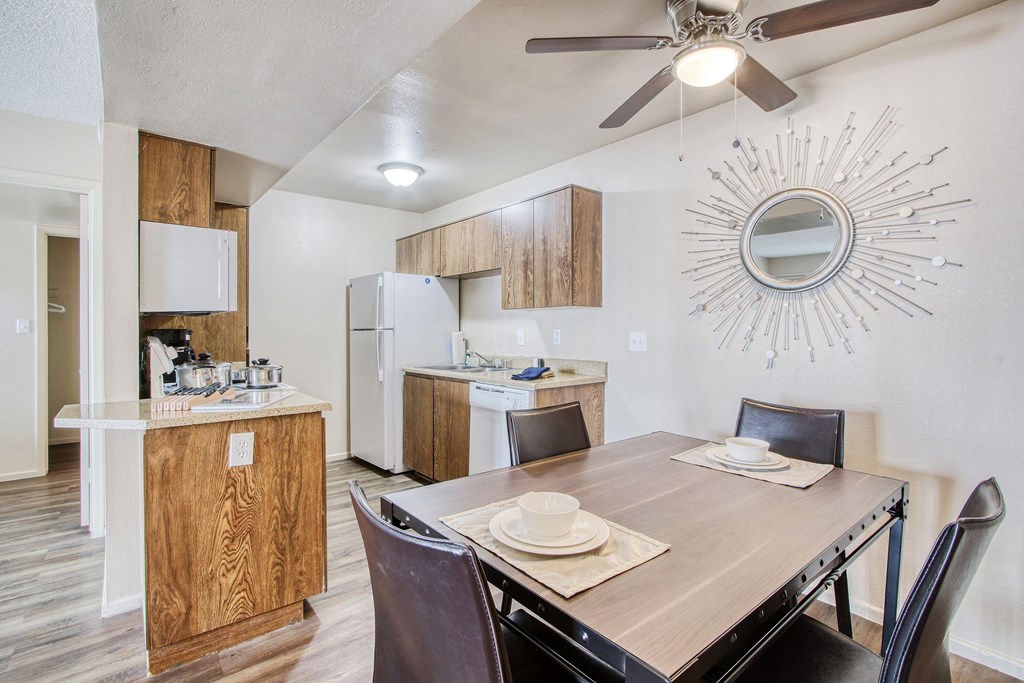 a dining room with a table and chairs and a kitchen