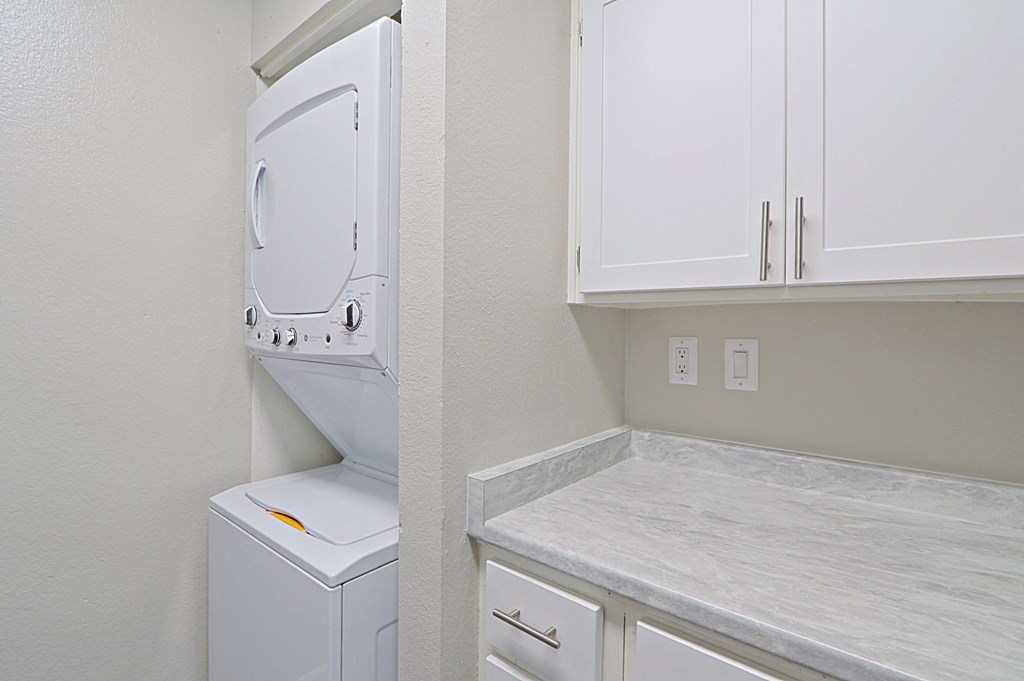 an empty laundry room with a washer and dryer