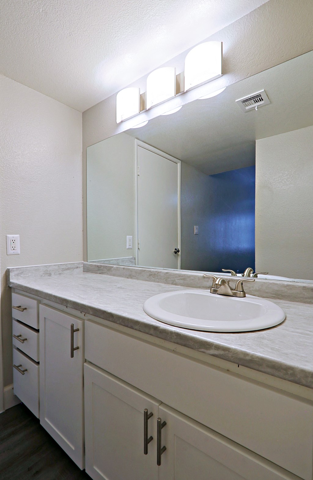 a bathroom with a sink and a large mirror