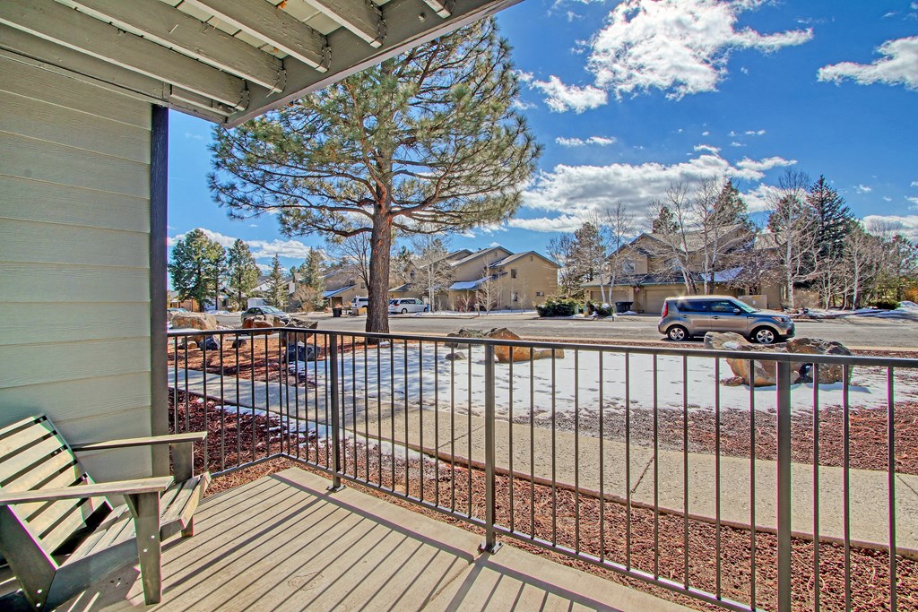 the view from the balcony of a house with a parking lot