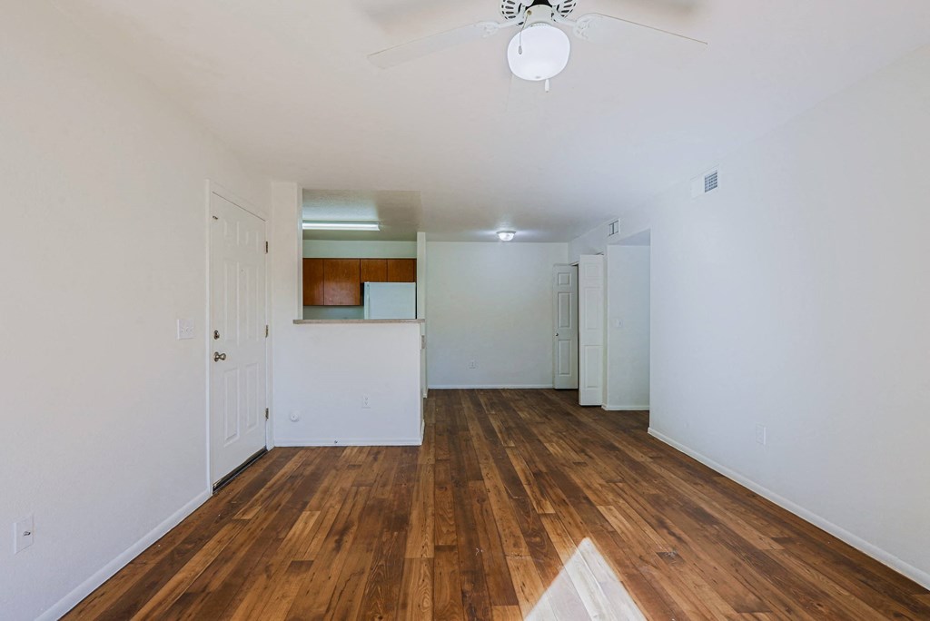 A room with wooden floors and white walls.