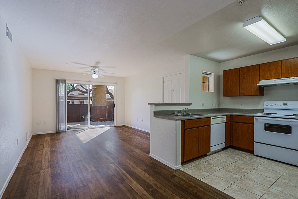 A kitchen with white appliances and wooden cabinets.