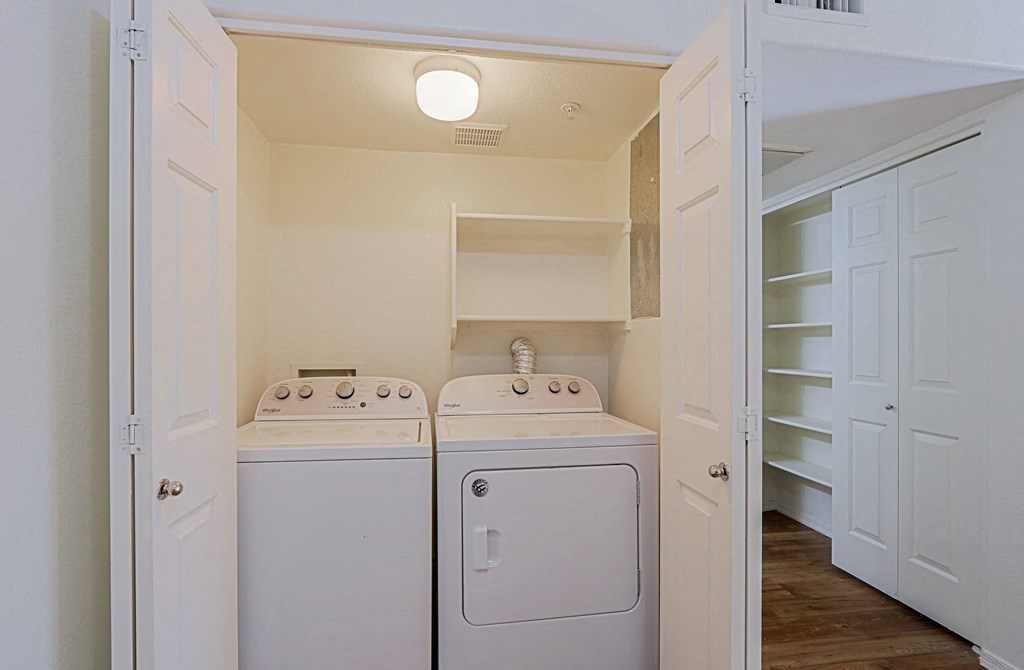 A small laundry room with a washer and dryer.