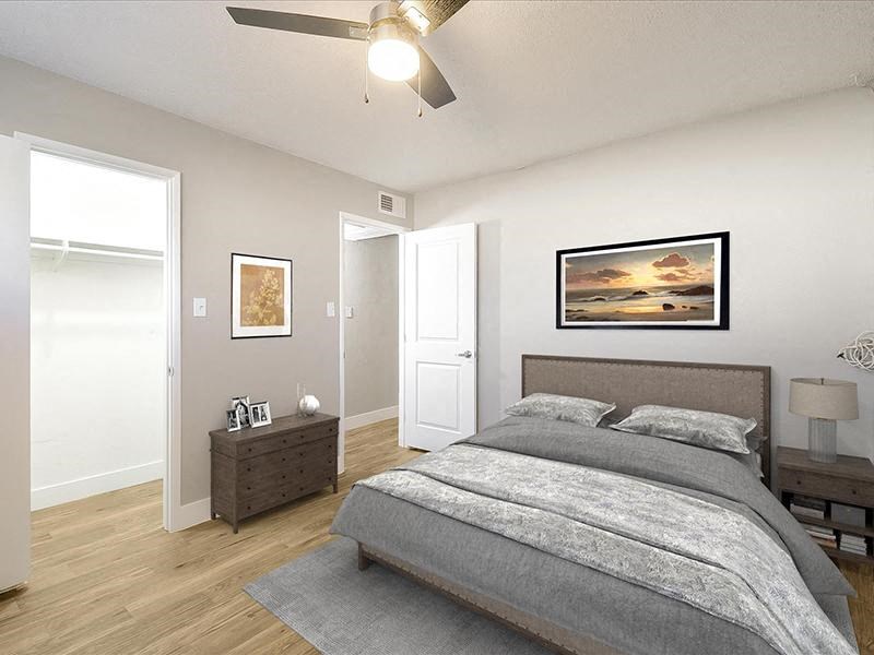 a bedroom with a bed and a ceiling fan