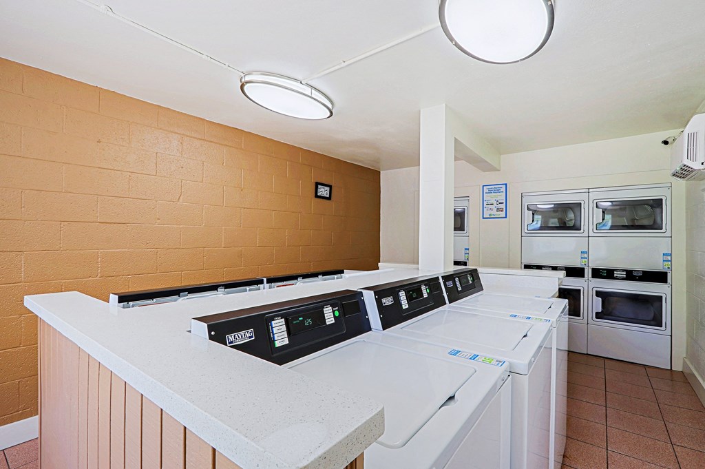 A row of white ovens are lined up in a room.