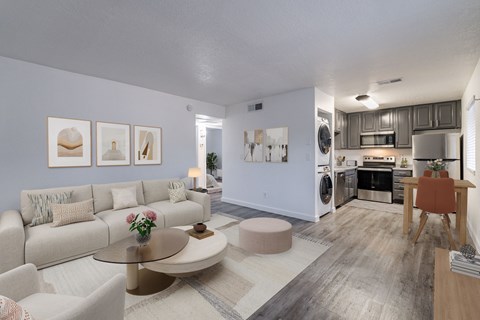 A modern living room with a white couch, a coffee table, and a dining table.