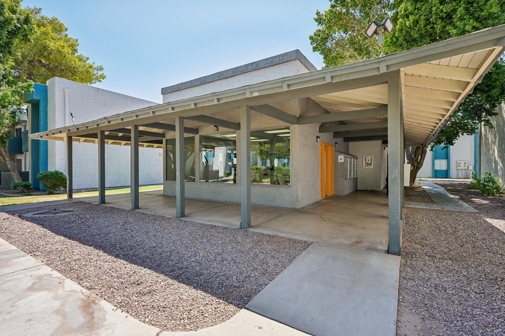 A modern building with a gravel area in front.