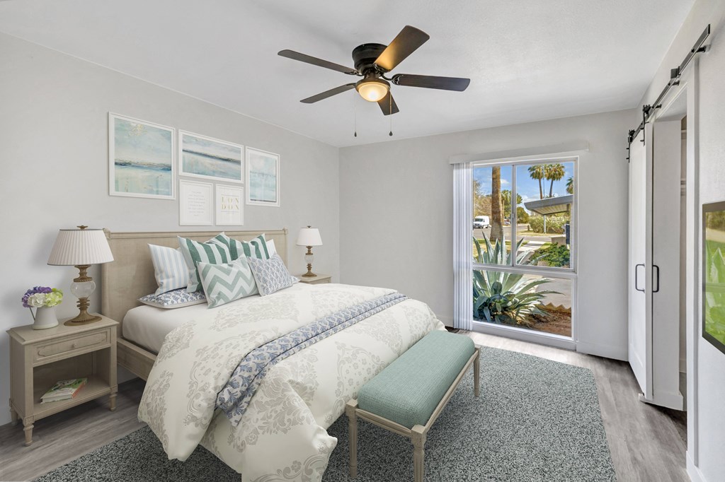 a bedroom with a bed and a ceiling fan