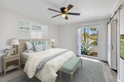 a bedroom with a bed and a ceiling fan