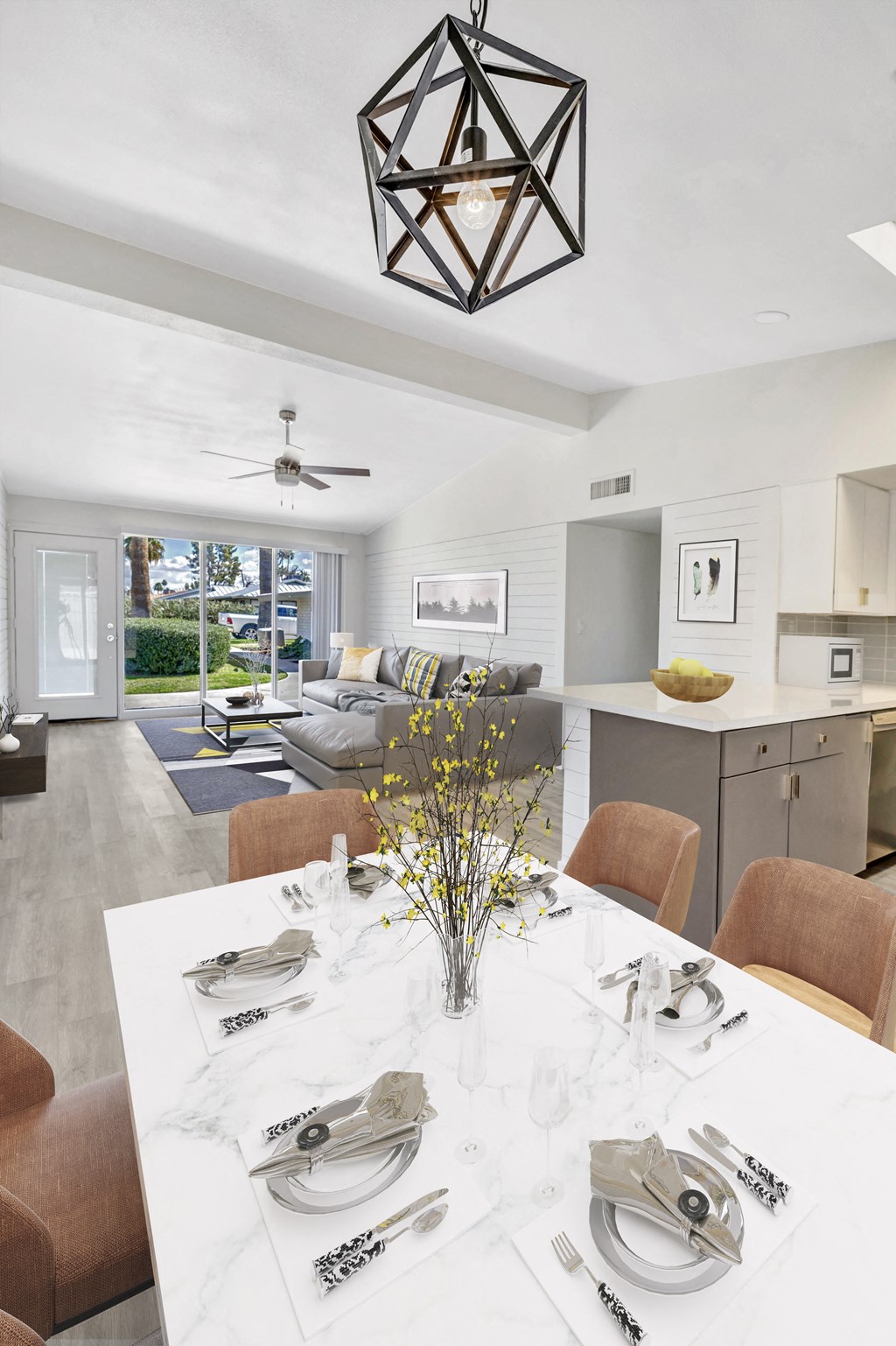 a living room and dining room with a table and chairs
