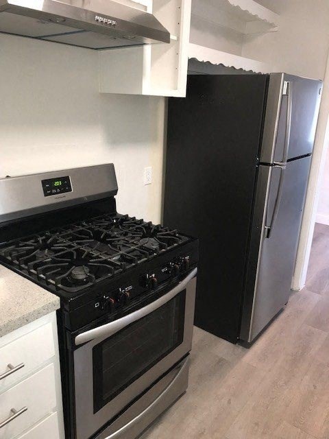 a kitchen with a stove and a refrigerator