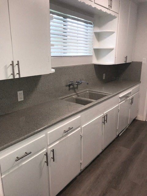 a kitchen with white cabinets and a sink
