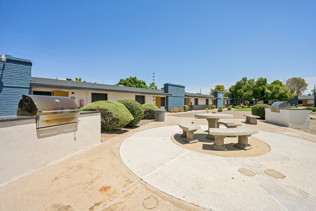 A courtyard with a table and chairs surrounded by buildings.