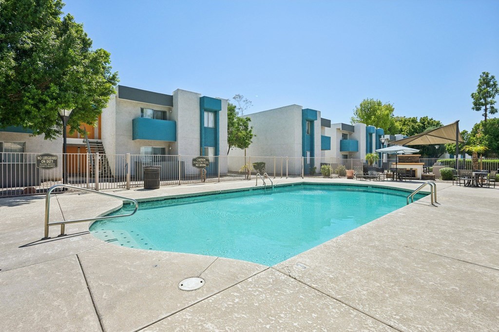 A swimming pool in front of a building.