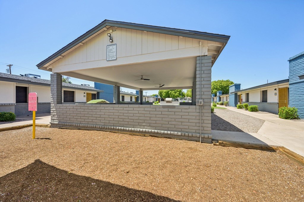 A small building with a white roof and a sign on it.