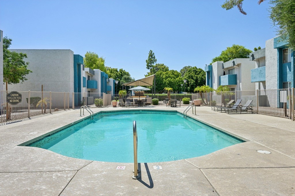 A rectangular pool with a diving board in the middle.
