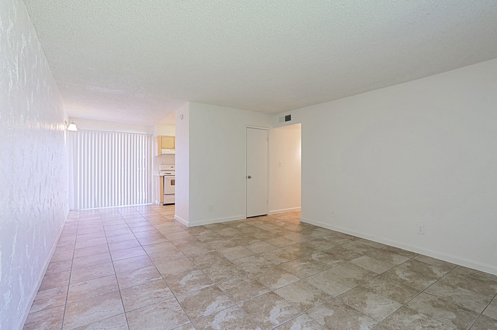 A room with a tiled floor and a white door.