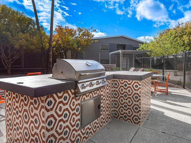 a barbecue grill sitting on top of a sidewalk