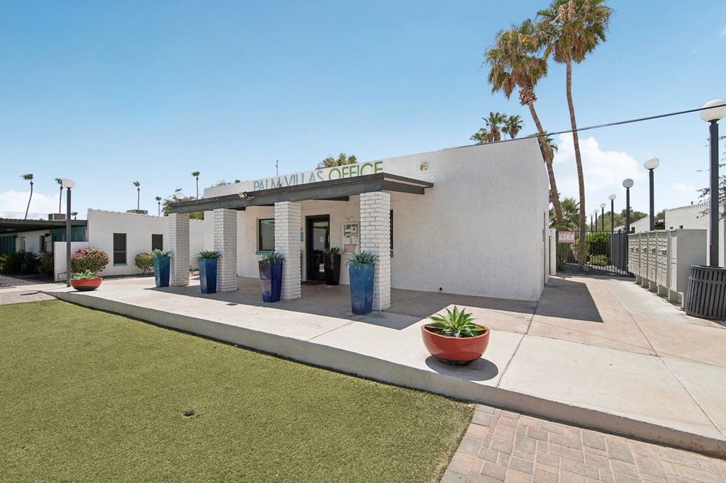A white building with a blue door and a sign that reads "Patriarchal Office".