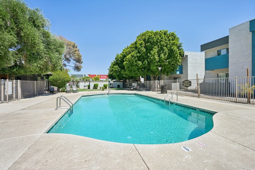 A rectangular pool with a metal railing around it.