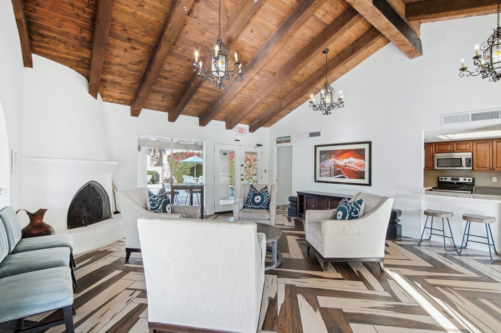 A living room with a fireplace and a painting on the wall at The Viridian, Scottsdale, AZ