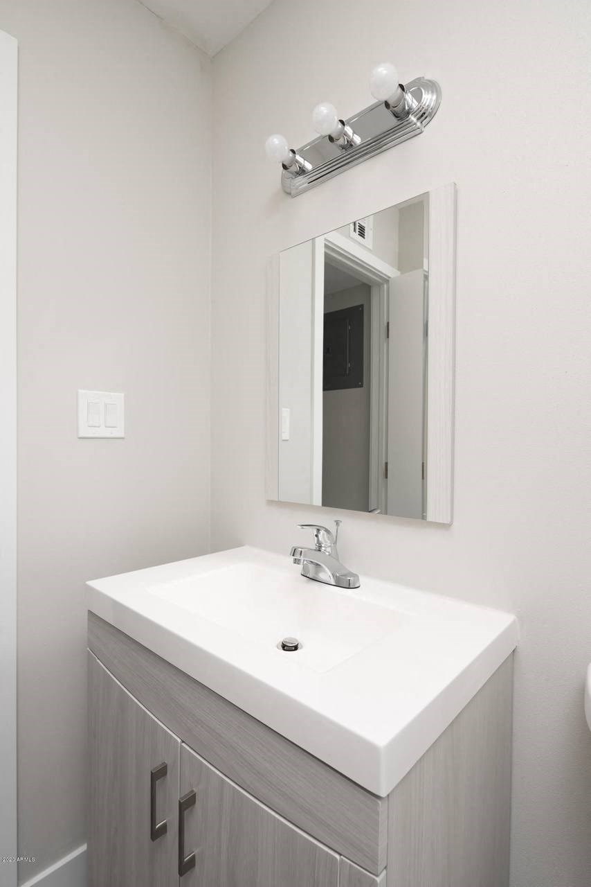 a bathroom with a sink and a mirror