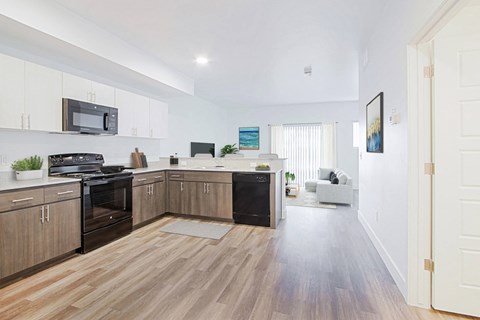 a kitchen with wooden floors and a stove and a microwave