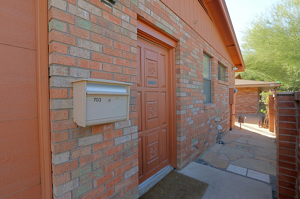 a brick building with a mailbox on the side of it
