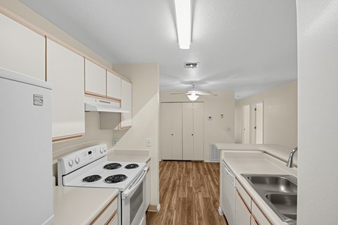 A kitchen with a stove top oven and a sink.