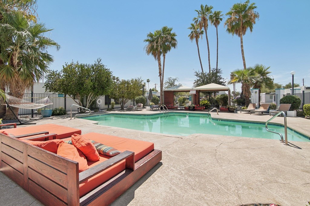 A pool area with a sun lounger and a pool table.