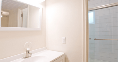 A white sink with a silver faucet in a bathroom.