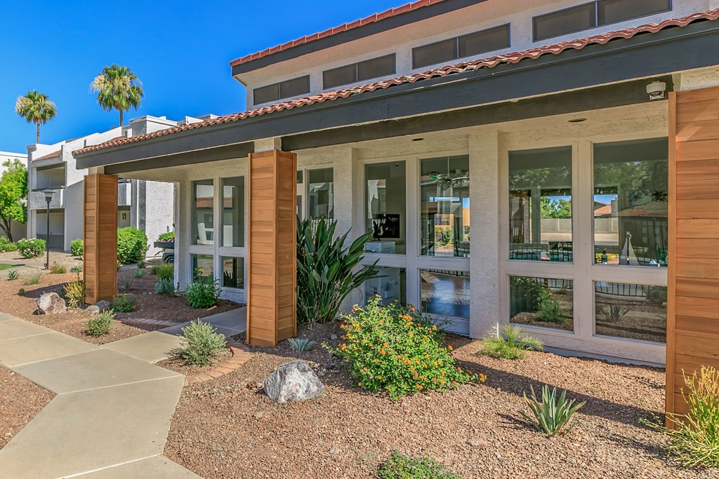 the front of a building with plants and rocks in front of it at Tides on Southern, Arizona