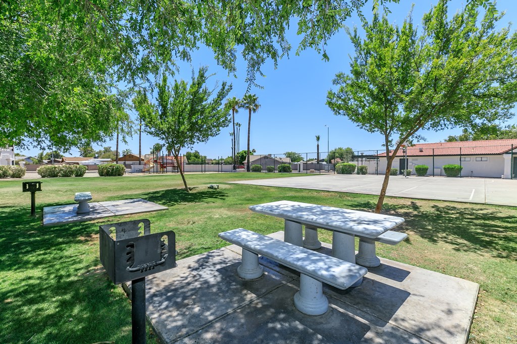 two picnic tables and a grill in a park at Tides at Mesa, Mesa, AZ, 85204
