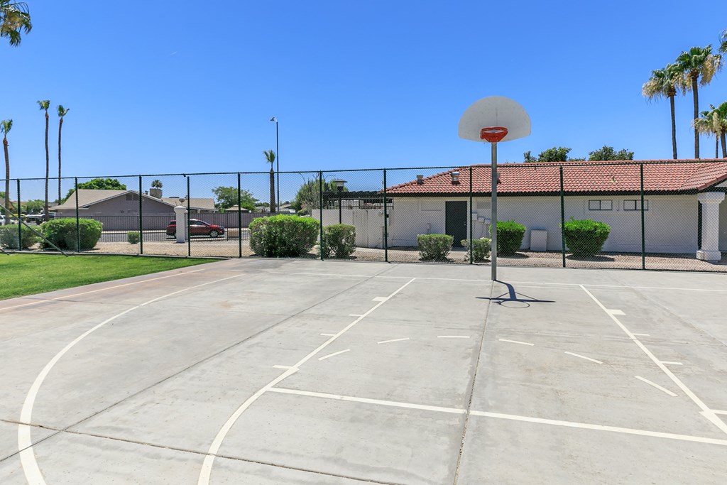 an outdoor basketball court in front of a house with a basketball hoop at Tides at Mesa, Mesa, 85204