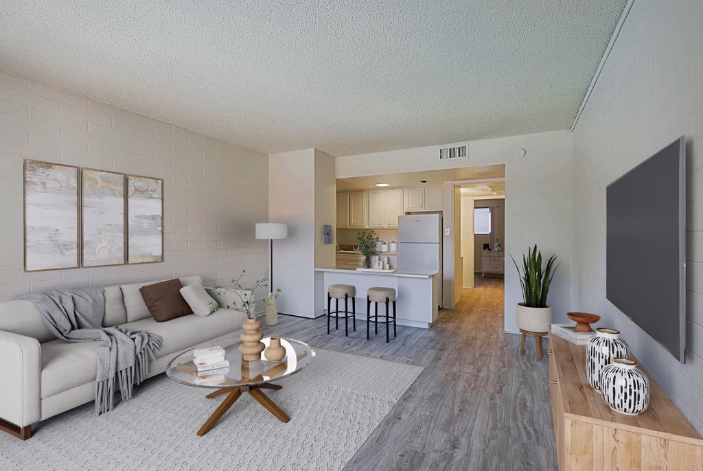 A living room with a grey couch and a coffee table.