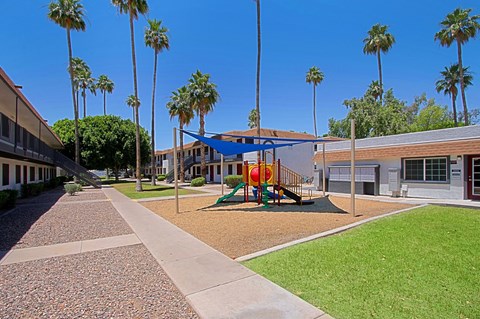 A playground with a slide and a swing set at Aspire Mesa, Mesa,  Arizona.