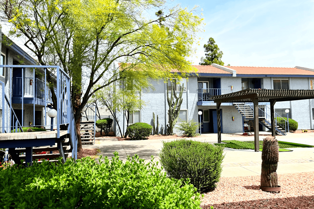a courtyard with a picnic table and a gazebo