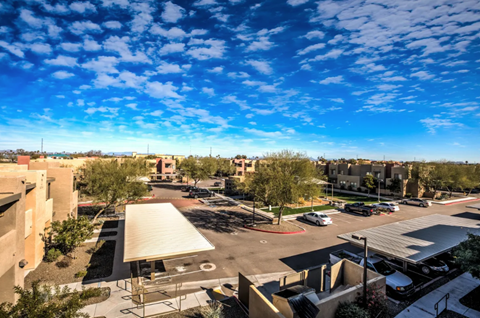 A parking lot with cars and a building in the background.