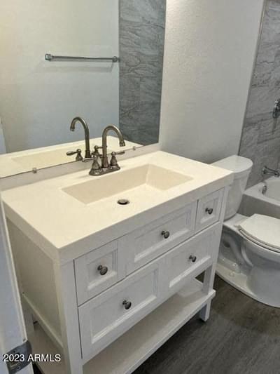 a bathroom with a white sink and a toilet