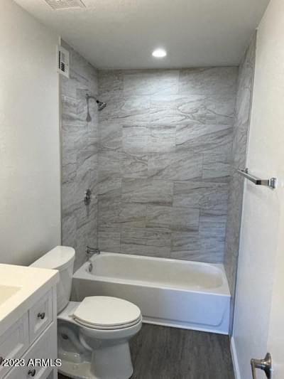 a bathroom with a toilet and a tub and a sink