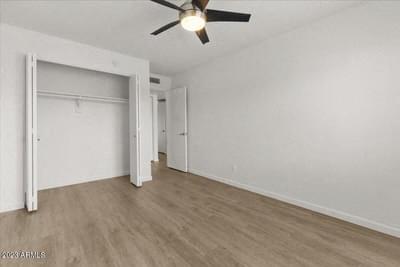 an empty bedroom with a ceiling fan and a closet