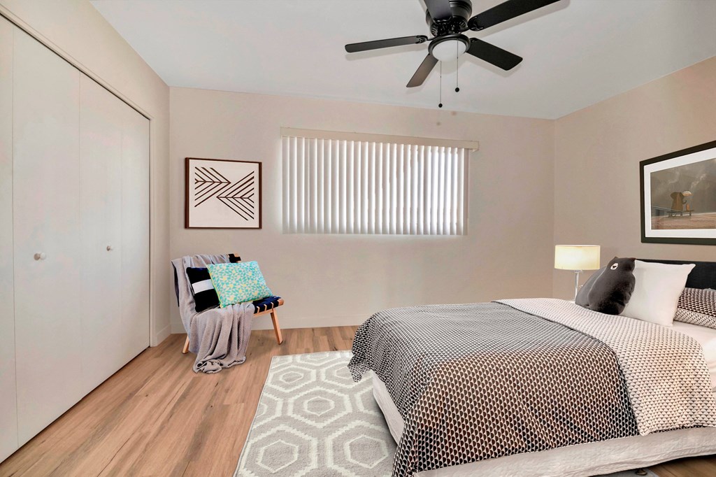 a bedroom with a bed and a ceiling fan